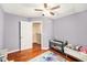 Bedroom with hardwood floors and ceiling fan at 290 Winchester Way, Palm Harbor, FL 34684