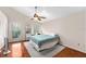 Bright bedroom featuring a ceiling fan, wood floors and plenty of natural light at 290 Winchester Way, Palm Harbor, FL 34684