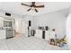 Bright kitchen area with white cabinets, stainless steel appliances, and tile flooring at 290 Winchester Way, Palm Harbor, FL 34684