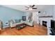 Bright living room with hardwood floors, fireplace, and neutral decor at 290 Winchester Way, Palm Harbor, FL 34684