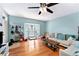 Sunny living area featuring hardwood floors, large bay window, and comfortable seating at 290 Winchester Way, Palm Harbor, FL 34684