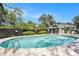 A beautiful community pool area featuring crystal clear water, and a covered seating area for relaxation near the water at 290 Winchester Way, Palm Harbor, FL 34684