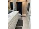 Bright bathroom with double vanity, tiled shower, and modern fixtures at 3037 Jacob Crossing Ln, Holiday, FL 34691