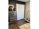 A bedroom featuring a dresser, closet, and exercise equipment at 3037 Jacob Crossing Ln, Holiday, FL 34691
