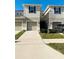 Inviting townhomes featuring attached garages, neutral paint, and well-maintained landscaping at 3037 Jacob Crossing Ln, Holiday, FL 34691
