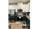 Modern kitchen features stainless steel appliances, white upper cabinets, and sleek countertops at 3037 Jacob Crossing Ln, Holiday, FL 34691
