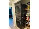 Modern laundry closet with stacked washer and dryer and shelving for storage of detergent and other supplies at 3037 Jacob Crossing Ln, Holiday, FL 34691