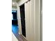 Modern laundry closet with stacked washer and dryer and sliding doors at 3037 Jacob Crossing Ln, Holiday, FL 34691