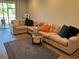 Spacious living room featuring a large sectional sofa, wood floors and stylish decor at 3037 Jacob Crossing Ln, Holiday, FL 34691