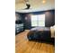 Comfortable bedroom with a fan, large window, and dark gray walls at 3037 Jacob Crossing Ln, Holiday, FL 34691