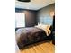 Cozy main bedroom with a large bed, soft bedding, and ample natural light at 3037 Jacob Crossing Ln, Holiday, FL 34691