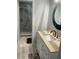 Stylish bathroom showcasing a vanity, decorative mirror, and a glass-enclosed shower at 3054 Pelican Pl, Clearwater, FL 33762
