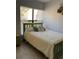 Cozy bedroom with a comfortable bed, bright window, and minimalist decor at 3054 Pelican Pl, Clearwater, FL 33762