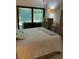 Comfortable bedroom with a large window overlooking the greenery outside at 3054 Pelican Pl, Clearwater, FL 33762