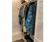 Well-organized closet with a variety of clothing items on hangers and floor storage at 3054 Pelican Pl, Clearwater, FL 33762