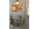 Cozy dining area features a glass table, seating for four, and stylish decor at 3054 Pelican Pl, Clearwater, FL 33762
