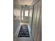 Inviting hallway with a patterned rug, white closet and ample natural light at 3054 Pelican Pl, Clearwater, FL 33762