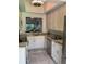 Modern kitchen featuring sleek white cabinetry and stainless steel appliances at 3054 Pelican Pl, Clearwater, FL 33762