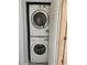 Convenient laundry closet with stacked washer and dryer units for efficient use of space at 3054 Pelican Pl, Clearwater, FL 33762