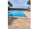 Sparkling community pool showcasing a spacious deck and serene water views at 3054 Pelican Pl, Clearwater, FL 33762