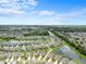 A high-angle view showcases the residential community with ponds and green spaces under a blue sky at 30639 Summer Sun Loop, Wesley Chapel, FL 33545