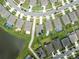 An aerial view of rooftops in a neighborhood with pools and driveways at 30639 Summer Sun Loop, Wesley Chapel, FL 33545