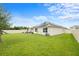 Fenced backyard with a patio seating area and well-maintained lawn provides ample space for outdoor activities at 30639 Summer Sun Loop, Wesley Chapel, FL 33545