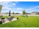Expansive backyard featuring a patio, a lush lawn, and a playset for outdoor enjoyment at 30639 Summer Sun Loop, Wesley Chapel, FL 33545