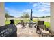 Landscaped backyard featuring a patio with seating, a well-maintained lawn, and a fenced perimeter at 30639 Summer Sun Loop, Wesley Chapel, FL 33545