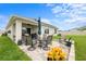 Spacious patio with outdoor seating overlooks the backyard lawn at 30639 Summer Sun Loop, Wesley Chapel, FL 33545