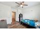 Bright bedroom showcasing wood-look flooring and a ceiling fan at 30639 Summer Sun Loop, Wesley Chapel, FL 33545