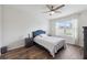 Bright bedroom with stylish furniture set, wood-look floors, and a ceiling fan at 30639 Summer Sun Loop, Wesley Chapel, FL 33545