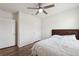 Bright bedroom showcasing wood-look flooring, a ceiling fan, and white walls and doors at 30639 Summer Sun Loop, Wesley Chapel, FL 33545