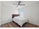 Bright bedroom features a ceiling fan, wood-look flooring, and a window providing ample natural light at 30639 Summer Sun Loop, Wesley Chapel, FL 33545