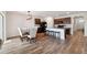 Open-concept kitchen and dining area with stylish lighting and hardwood floors, perfect for entertaining at 30639 Summer Sun Loop, Wesley Chapel, FL 33545