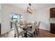 Dining area with sliding glass doors to backyard featuring modern light fixture, and hardwood floors at 30639 Summer Sun Loop, Wesley Chapel, FL 33545
