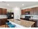 Spacious kitchen with granite countertops, center island with seating and stainless steel appliances at 30639 Summer Sun Loop, Wesley Chapel, FL 33545