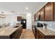 Modern kitchen featuring granite countertops, stainless steel appliances, and wood cabinetry for a stylish look at 30639 Summer Sun Loop, Wesley Chapel, FL 33545
