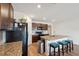 Bright open kitchen features a central island with seating, dark wood cabinetry, and stainless steel appliances at 30639 Summer Sun Loop, Wesley Chapel, FL 33545