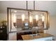 Modern kitchen lighting fixture highlights granite countertops, and stainless steel appliances at 30639 Summer Sun Loop, Wesley Chapel, FL 33545