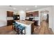 Stylish kitchen features stainless steel appliances, granite countertops, and a central island with seating at 30639 Summer Sun Loop, Wesley Chapel, FL 33545