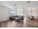 Comfortable living room showcases wood-look floors and a seamless transition to the dining area at 30639 Summer Sun Loop, Wesley Chapel, FL 33545