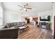Open concept living room features a large couch and connected eat-in kitchen area at 30639 Summer Sun Loop, Wesley Chapel, FL 33545