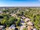 An aerial view of the property in a quiet neighborhood with tree lined streets and easy access to a pond at 3142 Crenshaw Ct, New Port Richey, FL 34655