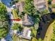 Aerial view of a home near a pond surrounded by lush greenery, showcasing the property's location at 3142 Crenshaw Ct, New Port Richey, FL 34655