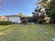 Charming backyard featuring a screened lanai, stepping stones and mature landscaping at 3142 Crenshaw Ct, New Port Richey, FL 34655