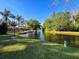 Waterfront home with backyard access, showcasing tranquil views and mature trees at 3142 Crenshaw Ct, New Port Richey, FL 34655