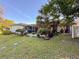 Landscaped backyard featuring a patio, lush landscaping, and mature trees, creating a tranquil oasis at 3142 Crenshaw Ct, New Port Richey, FL 34655