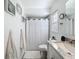 Bathroom featuring neutral colored walls, a decorative mirror, and a shower with a patterned white curtain at 3142 Crenshaw Ct, New Port Richey, FL 34655