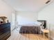 Bedroom with light wood floors and a black dresser featuring neutral decor and a ceiling fan at 3142 Crenshaw Ct, New Port Richey, FL 34655